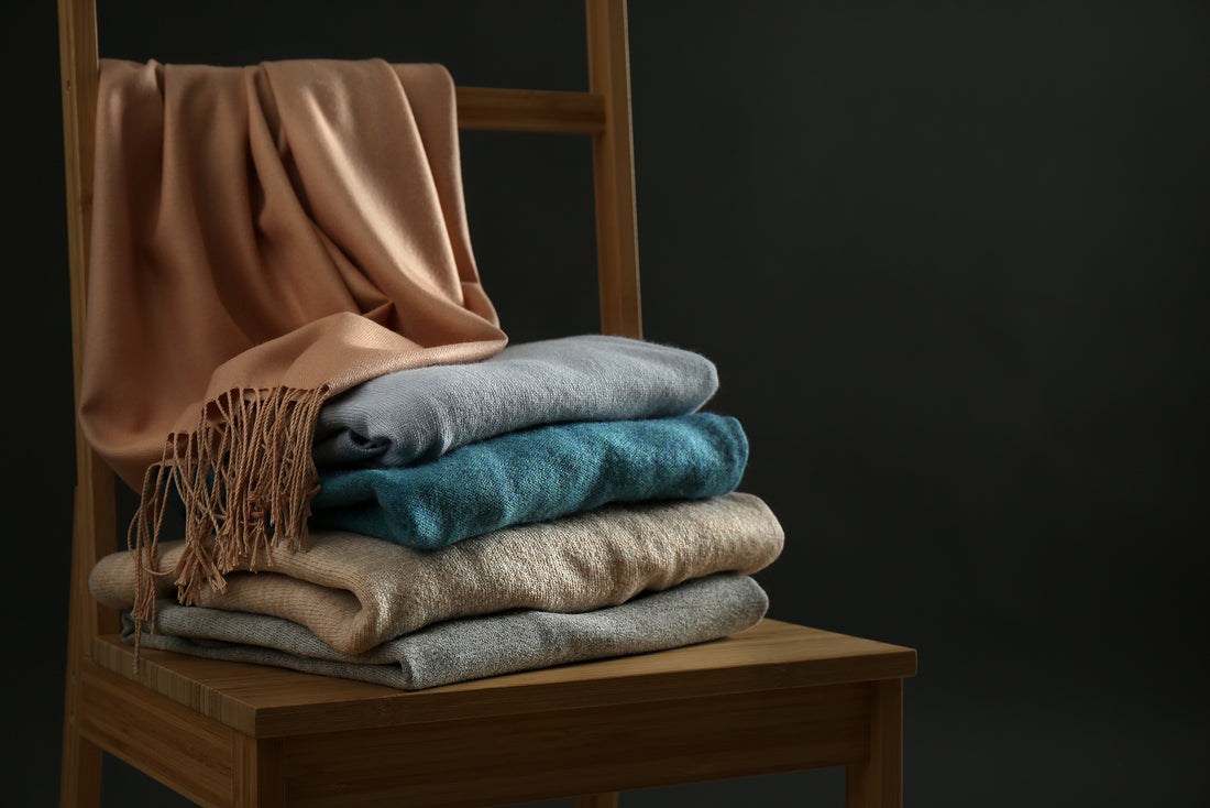 stack of cashmere clothe on chair