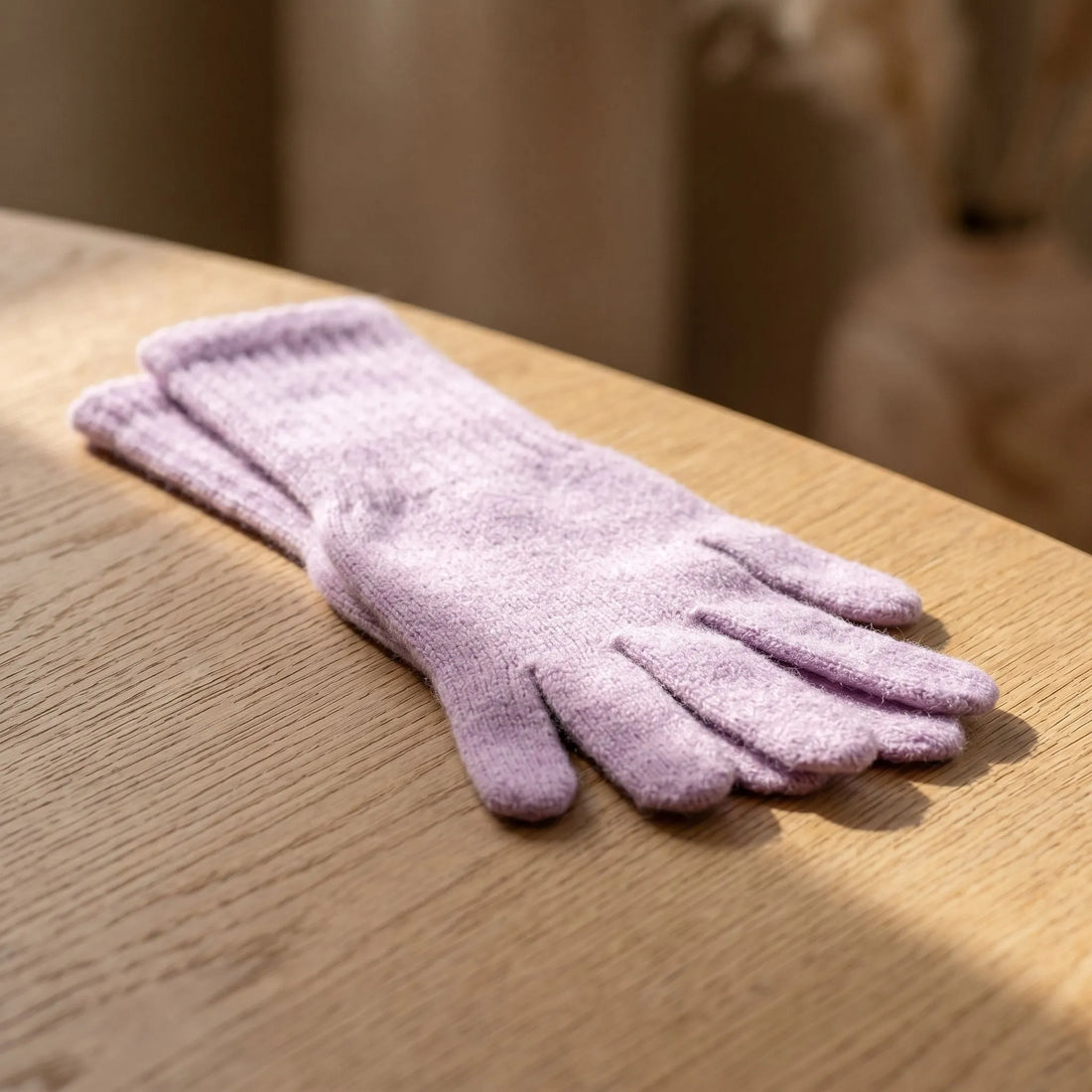 Model wearing Lilac Light Gloves with extended cuffs in a cozy winter setting, highlighting warmth and elegant style.